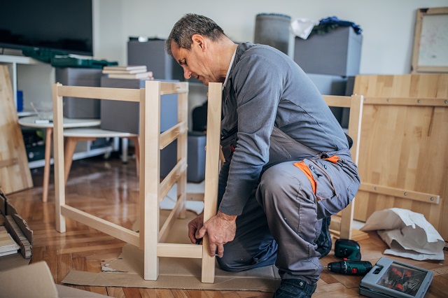 handyman assembling a wooden table